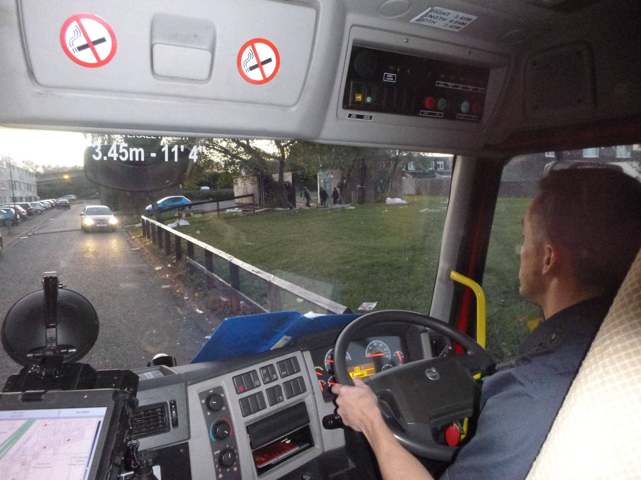 The view over the driver's shoulder of young people throwing missiles at a fire engine