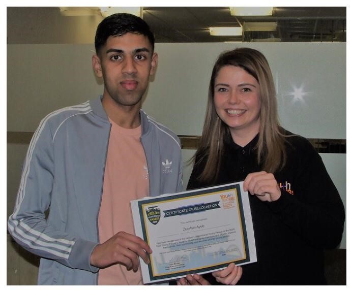 Zeeshan receiving his certificate from Zoe Jackson, Youth Focus North East