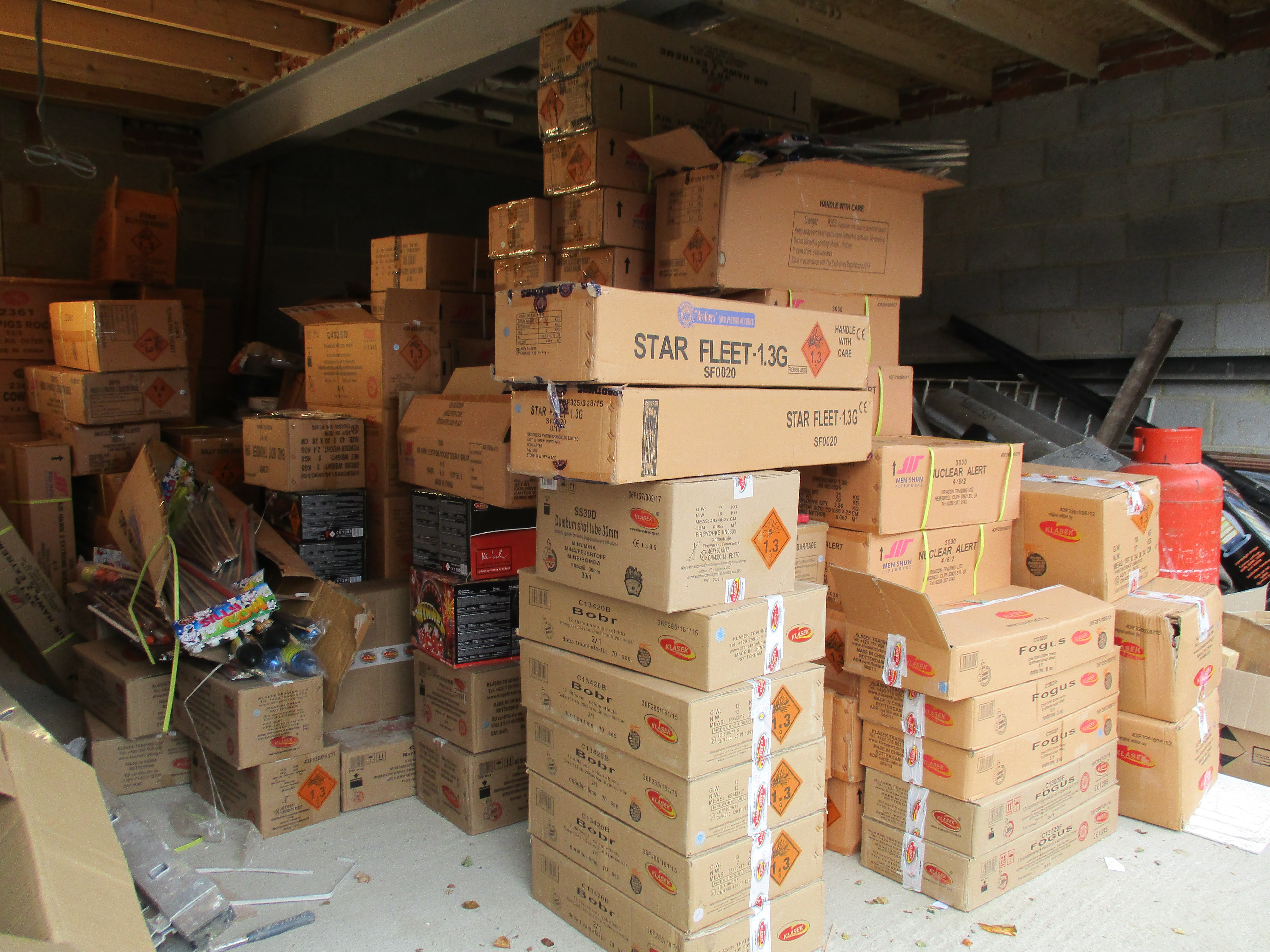 Piles of fireworks boxes in a garage