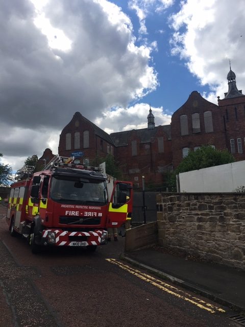 Fire engine and firefighters shown outside Mulgrave Terrace