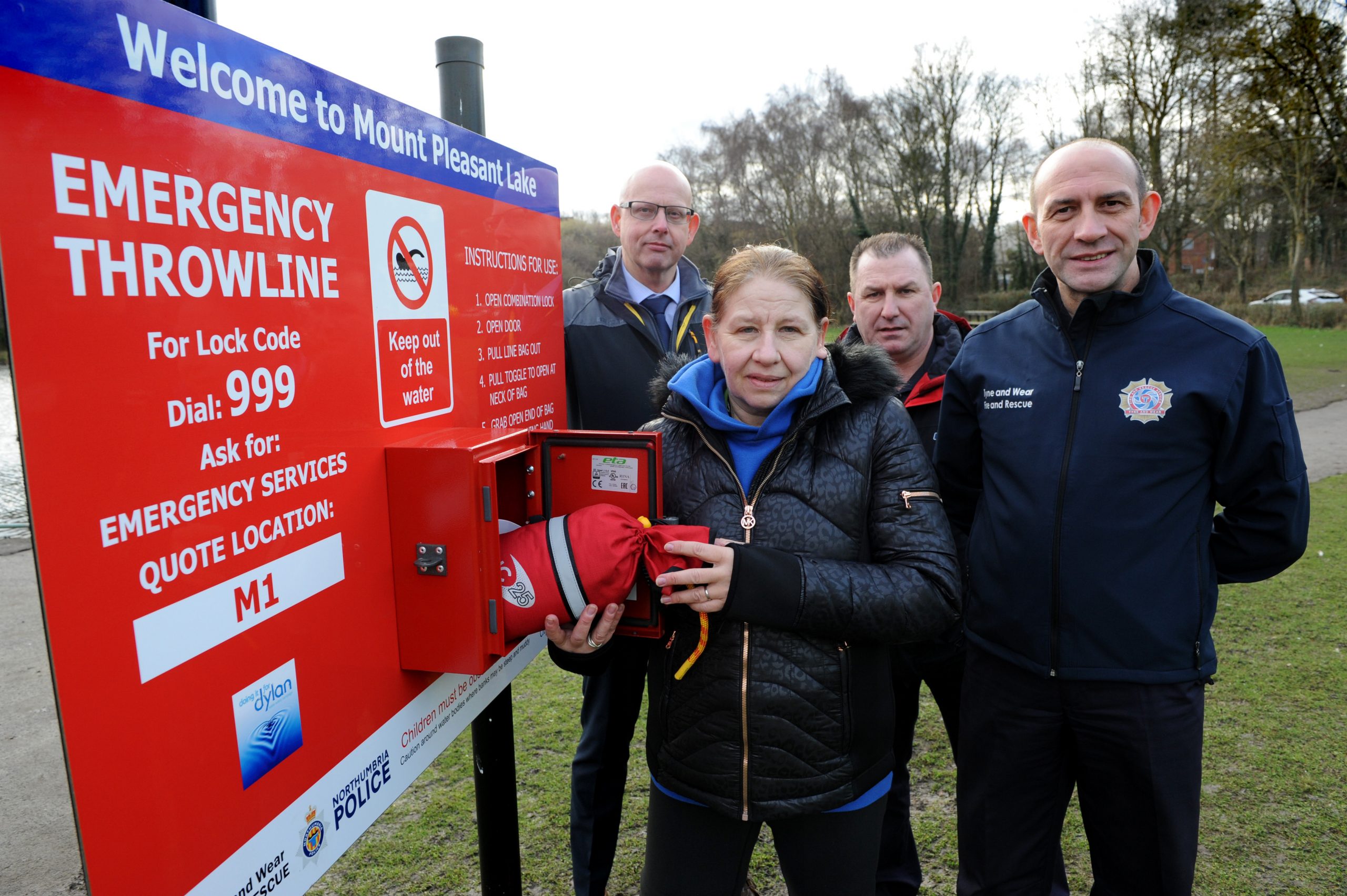 Cllr Fiona Miller, Cllr Tony Taylor, TWFRS Assistant Chief Fire Officer Peter Heath, and firefighter Tommy Richardson, with the newly installed Throwline at Mount Pleasant Lake, Fatfield, Washington.