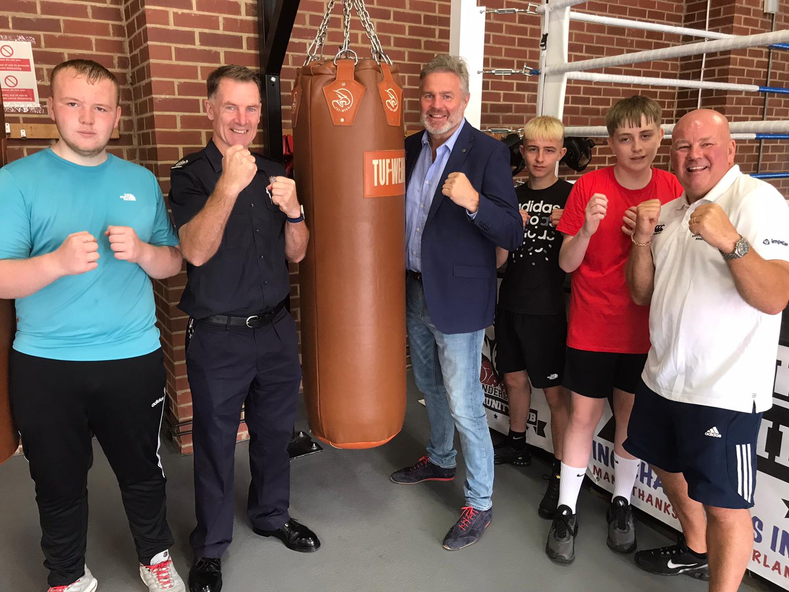 Logan Stone (young boxer), Richie Rickaby – Area Manager Community Safety (TWFRS), Glenn McCrory, Callum Hughes (young boxer), Josh Dickinson (young boxer) and Preston Brown (Head Coach and Firefighter) pictured inside the Sunderland Community Hub.