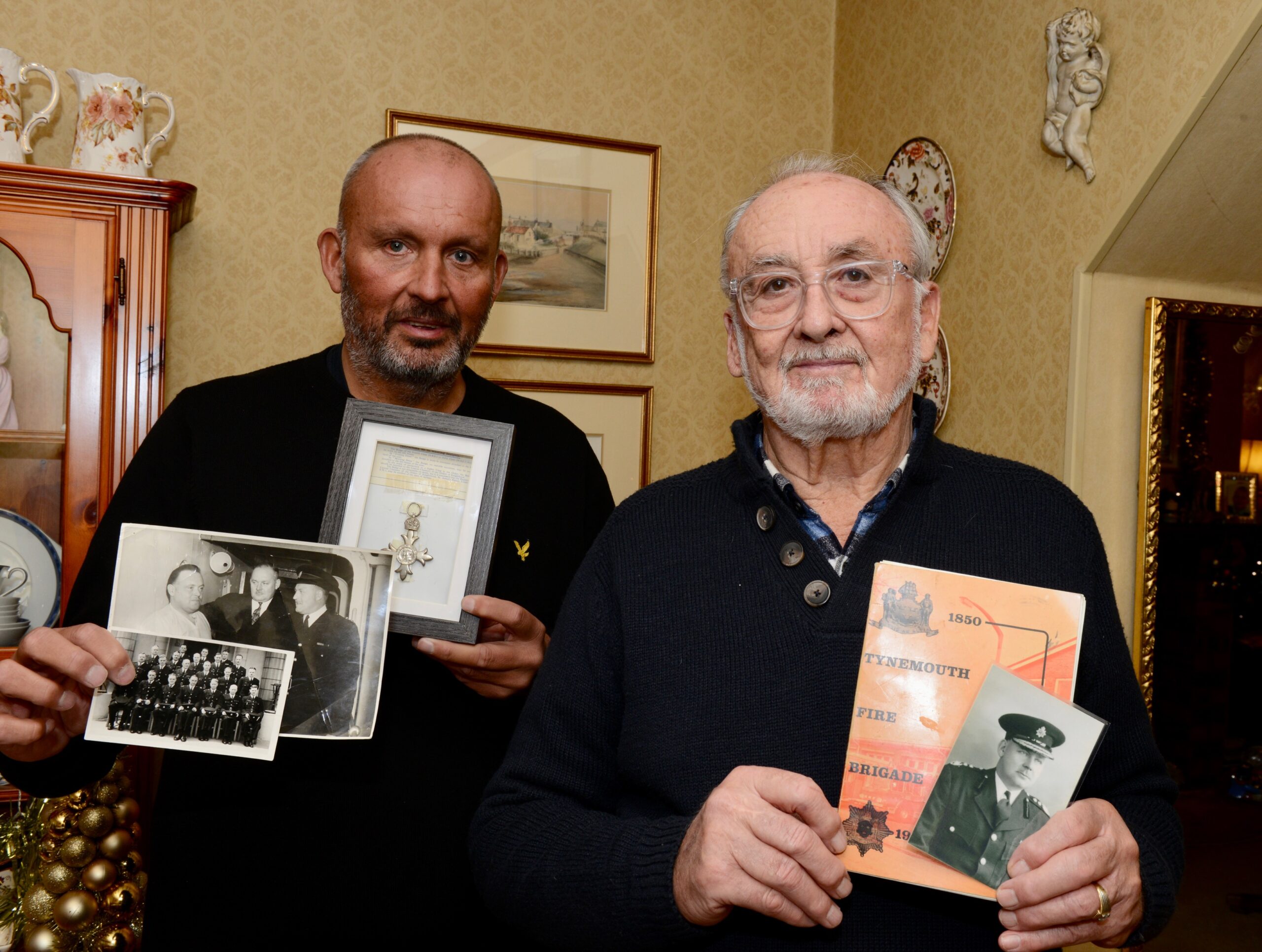 Scott and Wilf Andrews holding nostalgic items of Wilfred Andrews Snr that they have recently rediscovered.