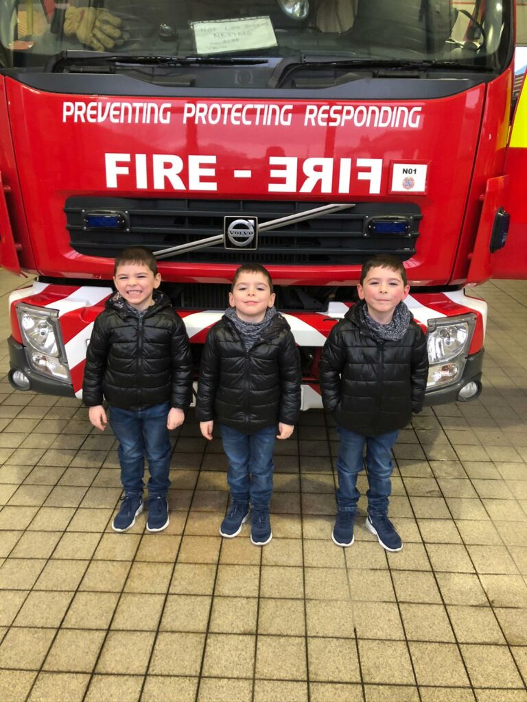 Oscar, Oliver and Owen outside of Sunderland Central Community Fire Station in December 2019