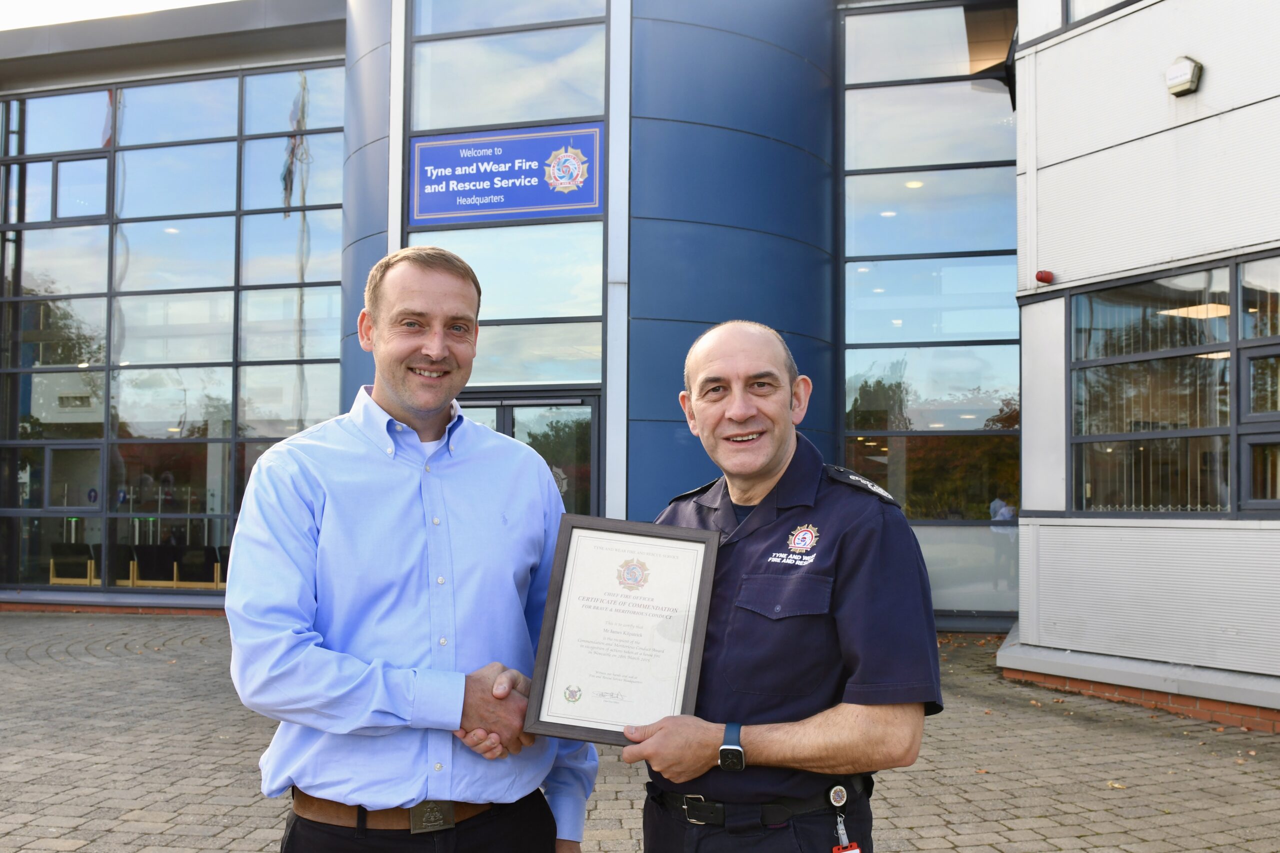 James Kilpatrick of Newcastle City Council is receiving his award from Chief Fire Officer Peter Heath outside of Service Headquarters in Washington.